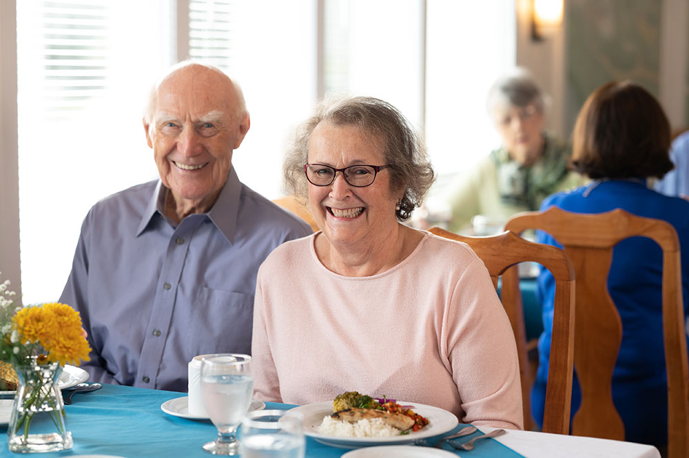 couple smiling at the dinner table