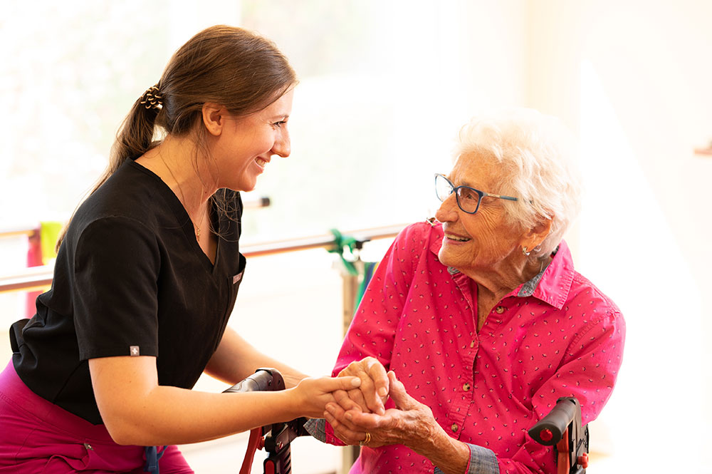 caregiver with smiling female Resident