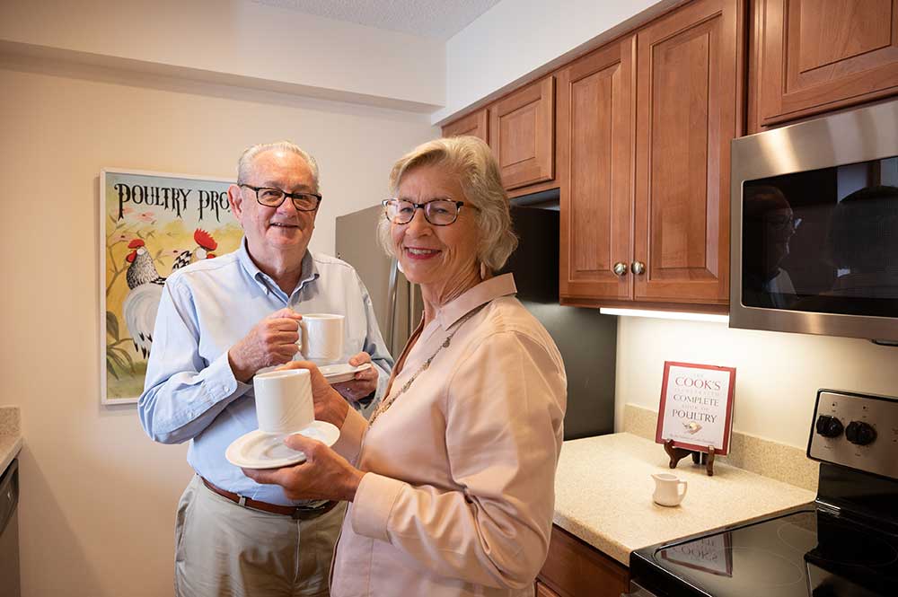 Couple drinking coffee in their kitchen