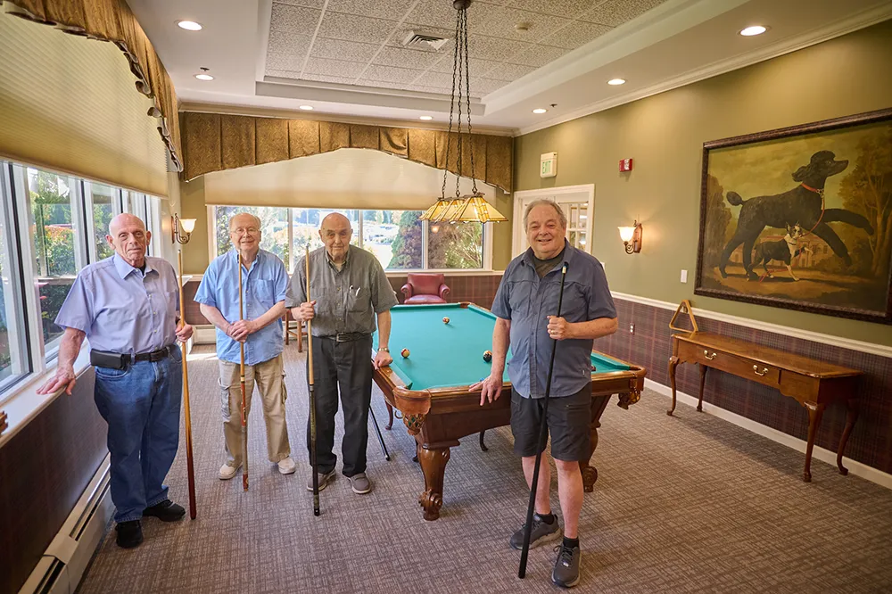men standing in front of a pool table