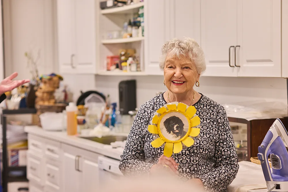 woman holding up a craft project