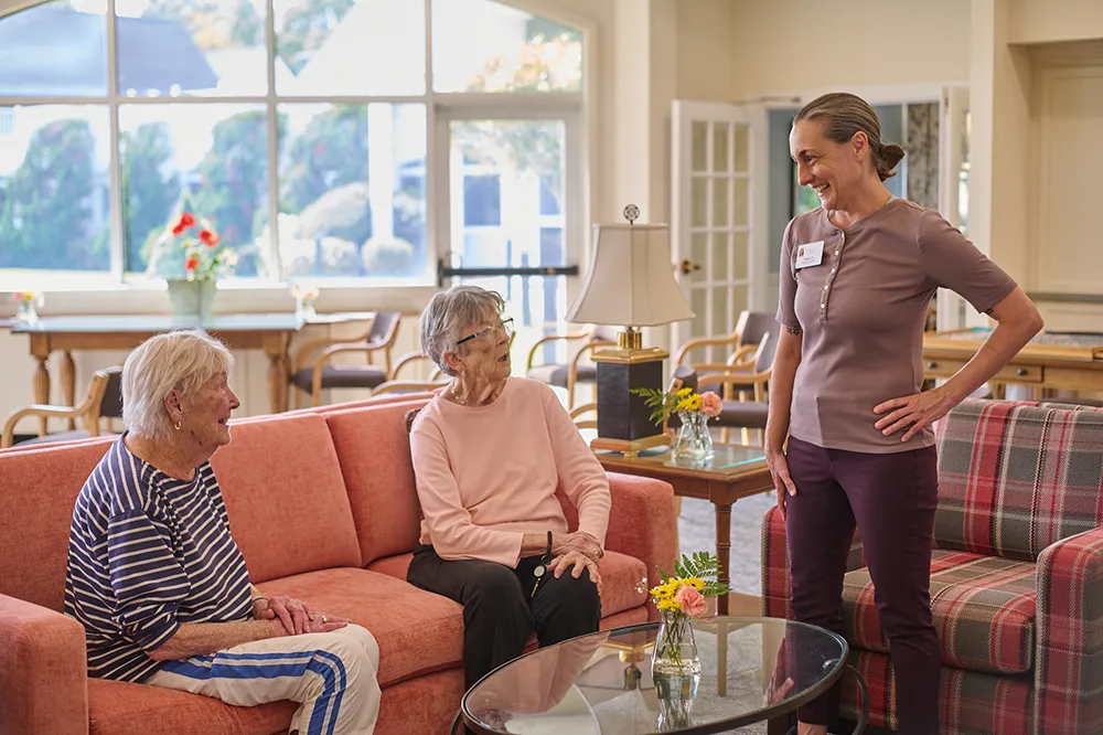 a team member speaking with two women